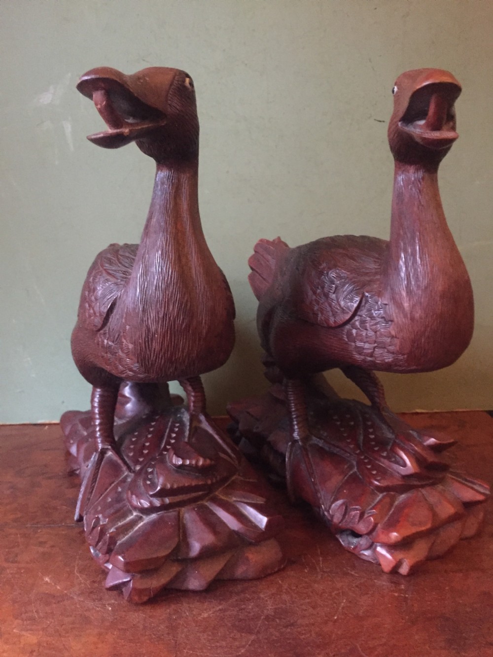 A pair of late nineteenth-century Chinese hardwood carved ducks with open beaks resting on sculpted bases. View III