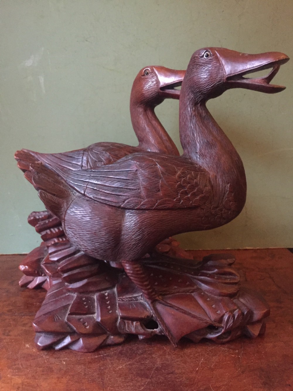 A pair of late nineteenth-century Chinese hardwood carved ducks with open beaks resting on sculpted bases. View IV