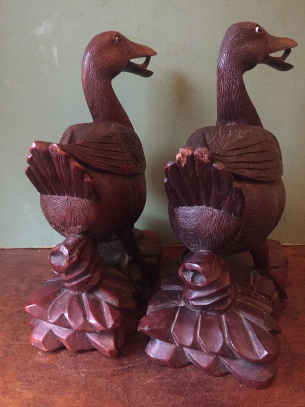 A pair of late nineteenth-century Chinese hardwood carved ducks with open beaks resting on sculpted bases. View V