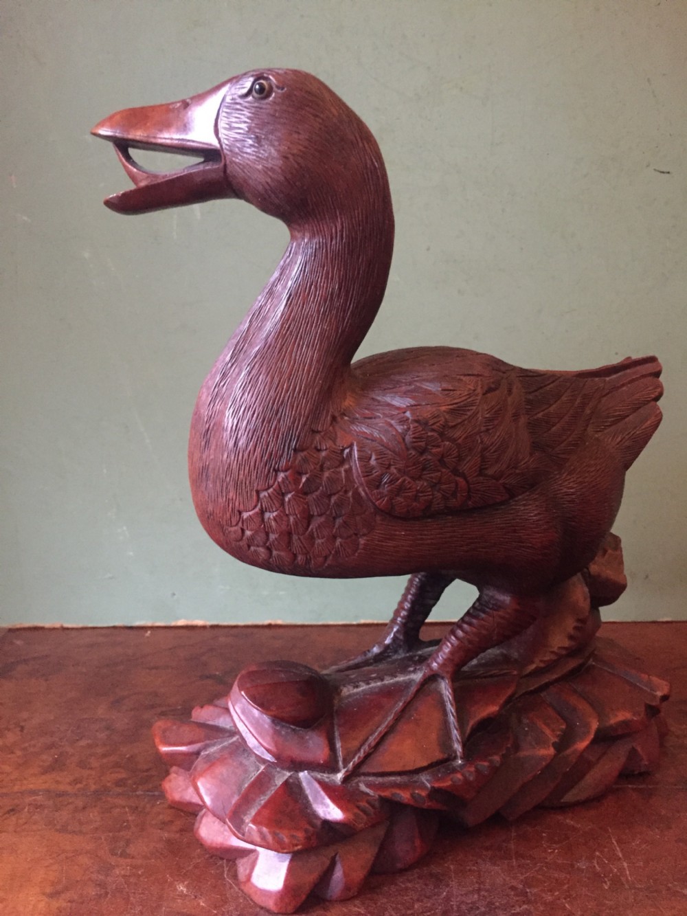 A pair of late nineteenth-century Chinese hardwood carved ducks with open beaks resting on sculpted bases. View VII