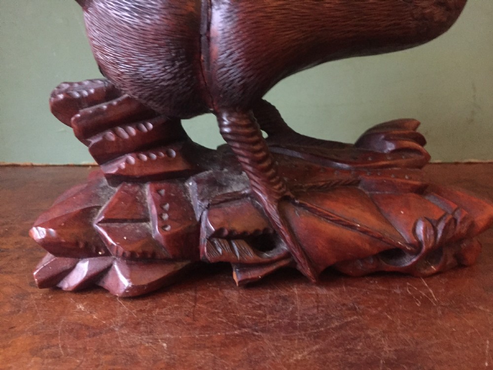 A pair of late nineteenth-century Chinese hardwood carved ducks with open beaks resting on sculpted bases. View VIII