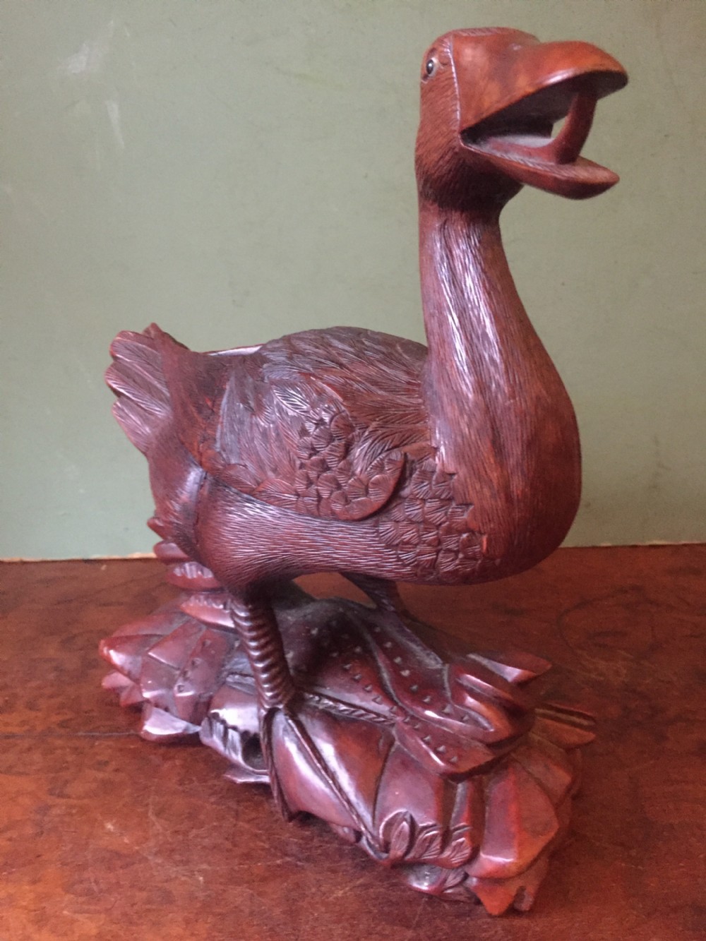 A pair of late nineteenth-century Chinese hardwood carved ducks with open beaks resting on sculpted bases. View X