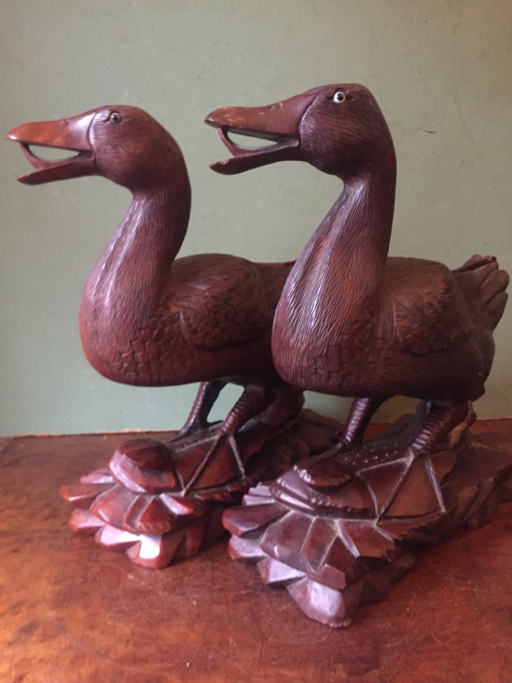 A pair of late nineteenth-century Chinese hardwood carved ducks with open beaks resting on sculpted bases. View XI