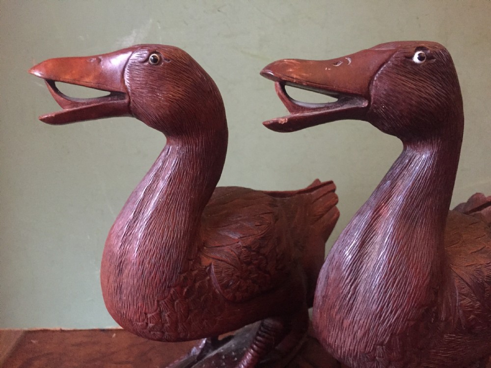 A pair of late nineteenth-century Chinese hardwood carved ducks with open beaks resting on sculpted bases. View XIII