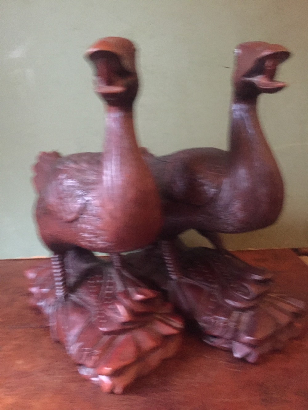 A pair of late nineteenth-century Chinese hardwood carved ducks with open beaks resting on sculpted bases. View XIV