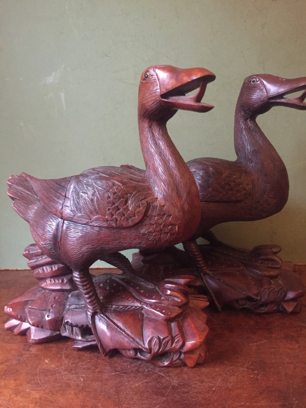 A pair of late nineteenth-century Chinese hardwood carved ducks with open beaks resting on sculpted bases. View XV