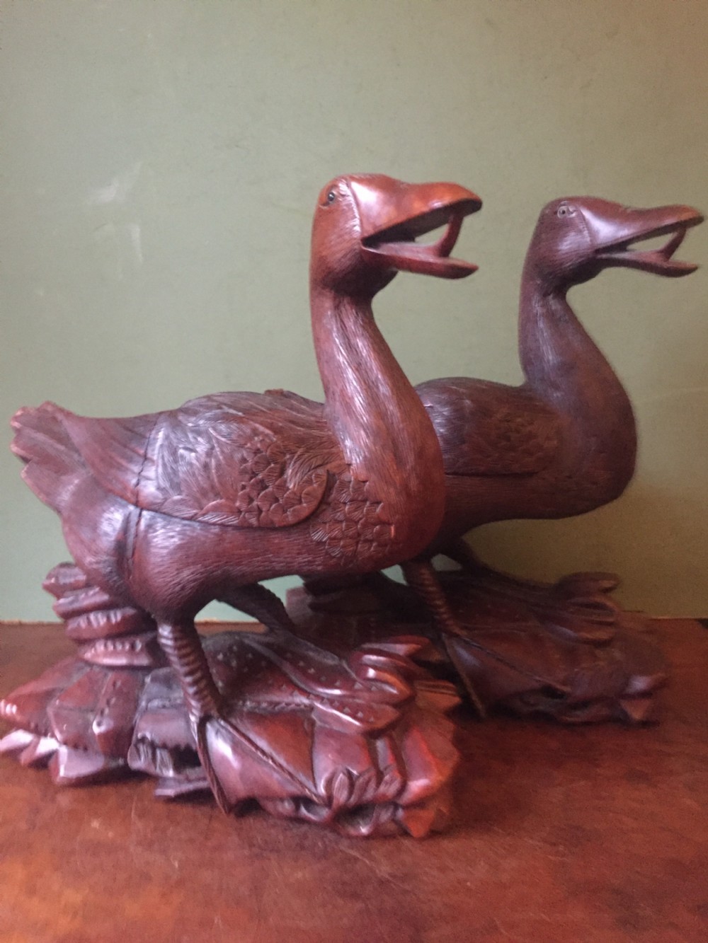 A pair of late nineteenth-century Chinese hardwood carved ducks with open beaks resting on sculpted bases. View XVI