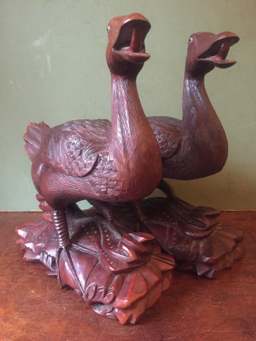A pair of late nineteenth-century Chinese hardwood carved ducks with open beaks resting on sculpted bases. View XVII