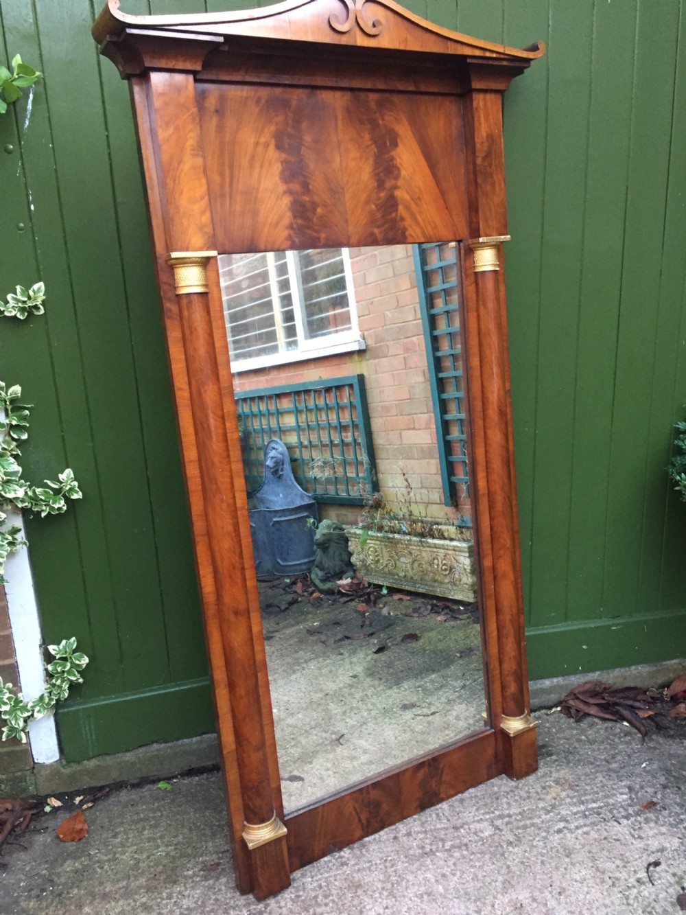 Early C19th Baltic region mahogany framed pier mirror with parcel-gilt column caps and bases .