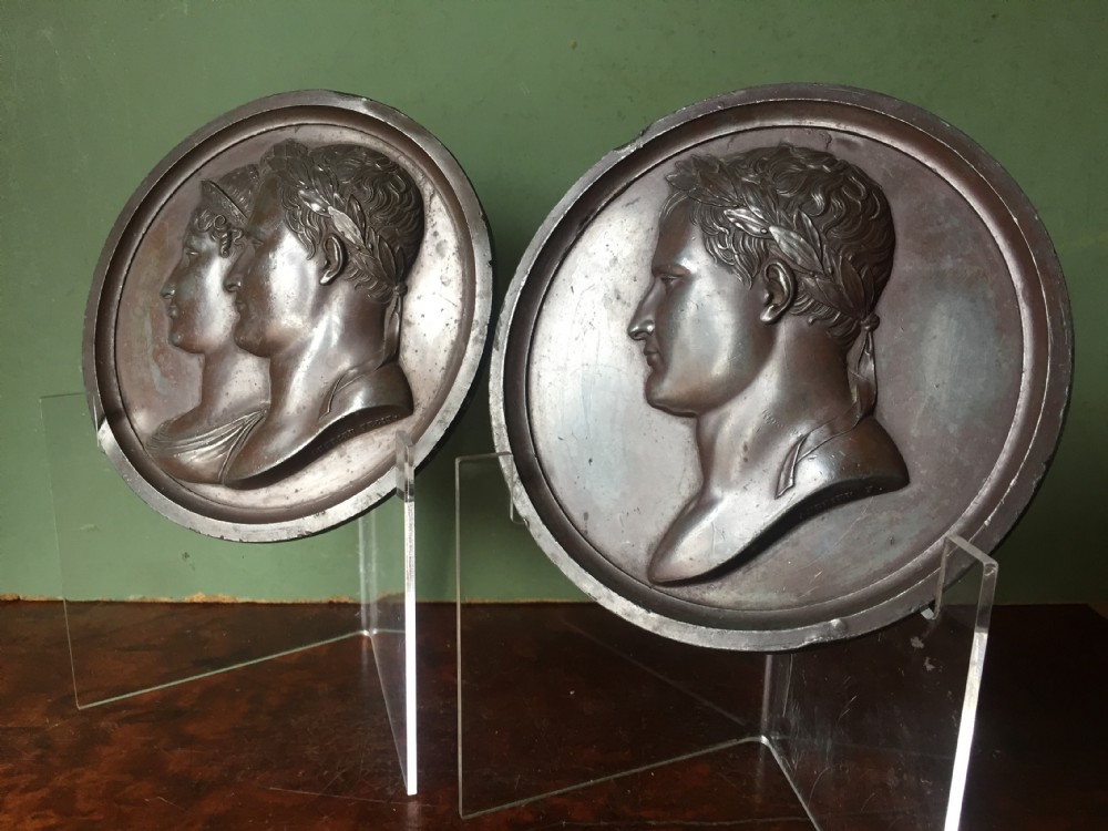 A pair of circular turned mahogany frames enclosing dark bronzed relief profile portraits of Napoleon and Marie-Louise under glass. View IV