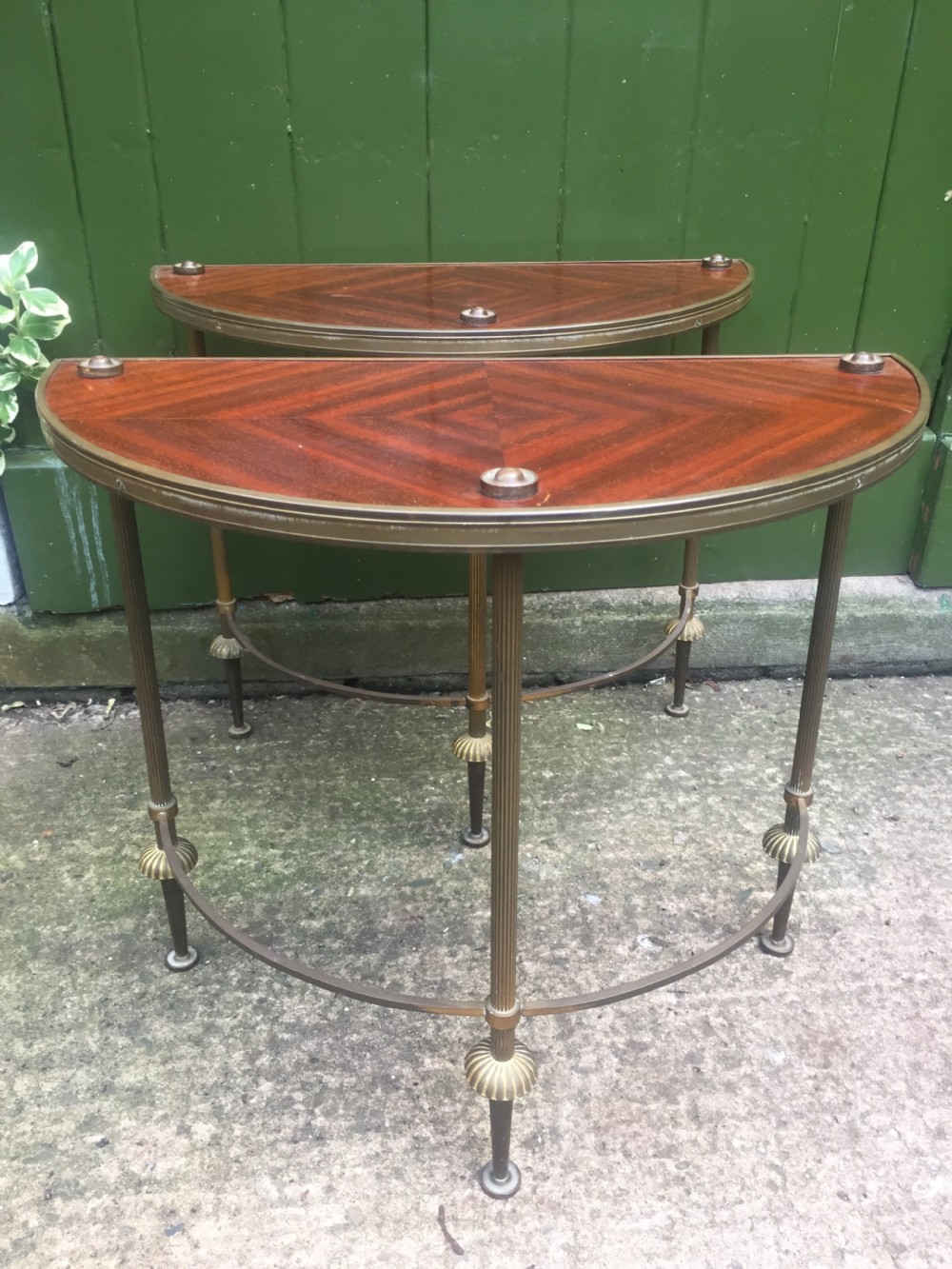 Pair of early C20th brass-framed semi-circular drinks or end tables with quarter-veneered mahogany tops. View V