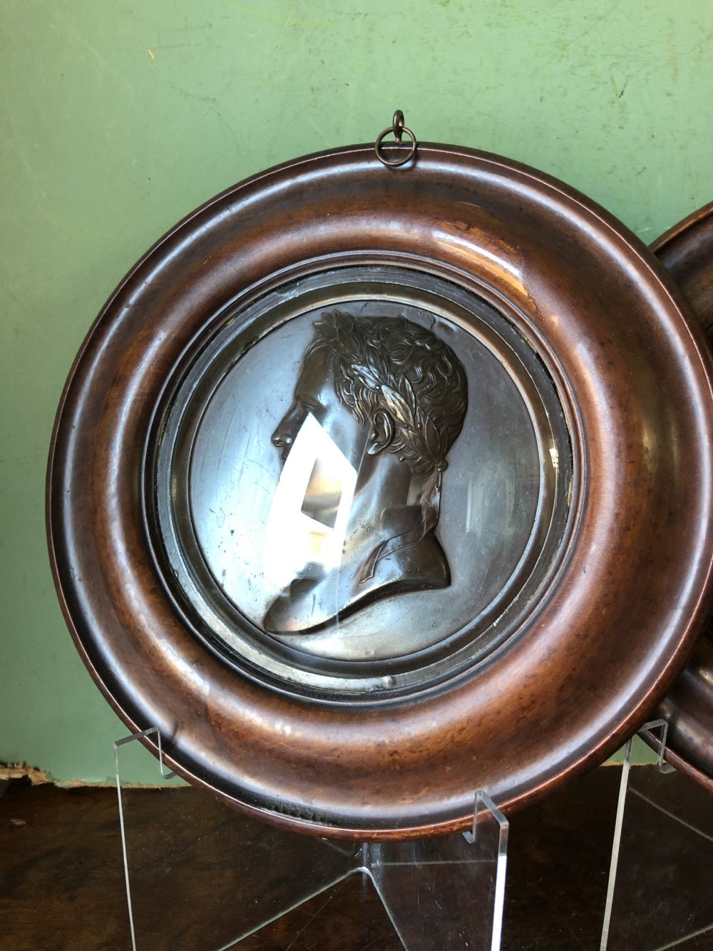 A pair of circular turned mahogany frames enclosing dark bronzed relief profile portraits of Napoleon and Marie-Louise under glass. View XII