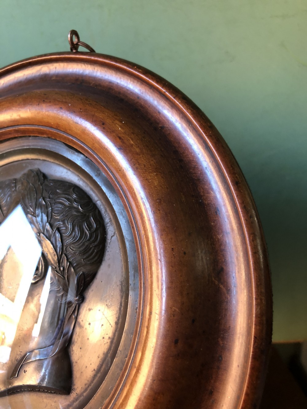 A pair of circular turned mahogany frames enclosing dark bronzed relief profile portraits of Napoleon and Marie-Louise under glass. View XIV