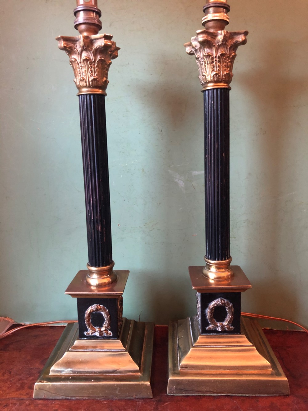 Pair of early C20th patinated and polished brass table lamps of classical column form.