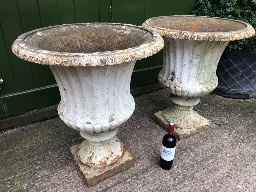 Large scale pair of early C19th Regency period cast-iron terrace or garden vases of campana form . View X