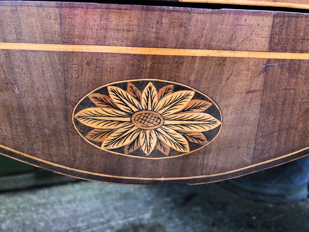 A late 18th-century George III mahogany sideboard featuring a serpentine front, floral marquetry inlay, tapering square legs with spade feet, and brass oval handles. View VII