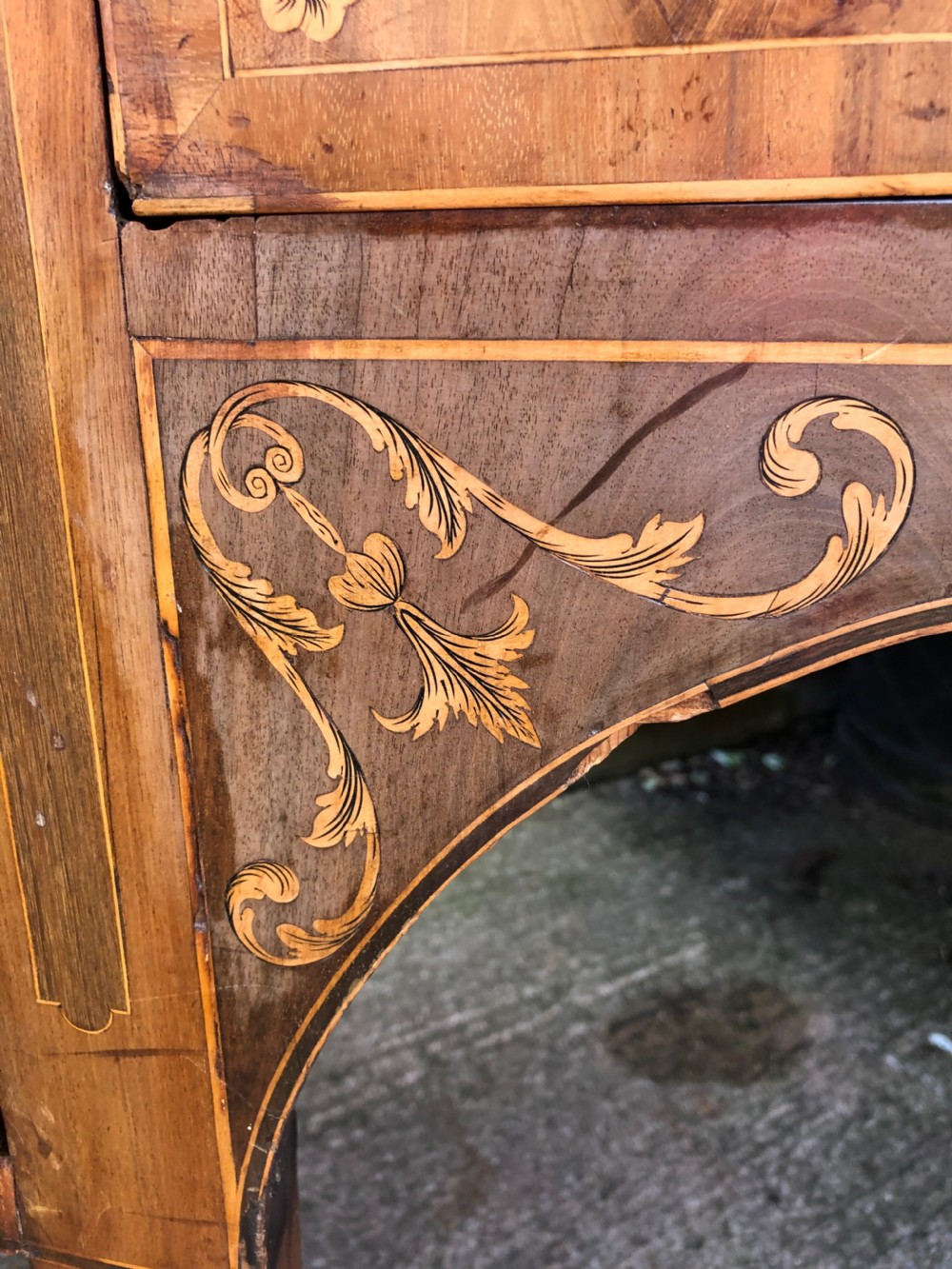 A late 18th-century George III mahogany sideboard featuring a serpentine front, floral marquetry inlay, tapering square legs with spade feet, and brass oval handles. View VIII