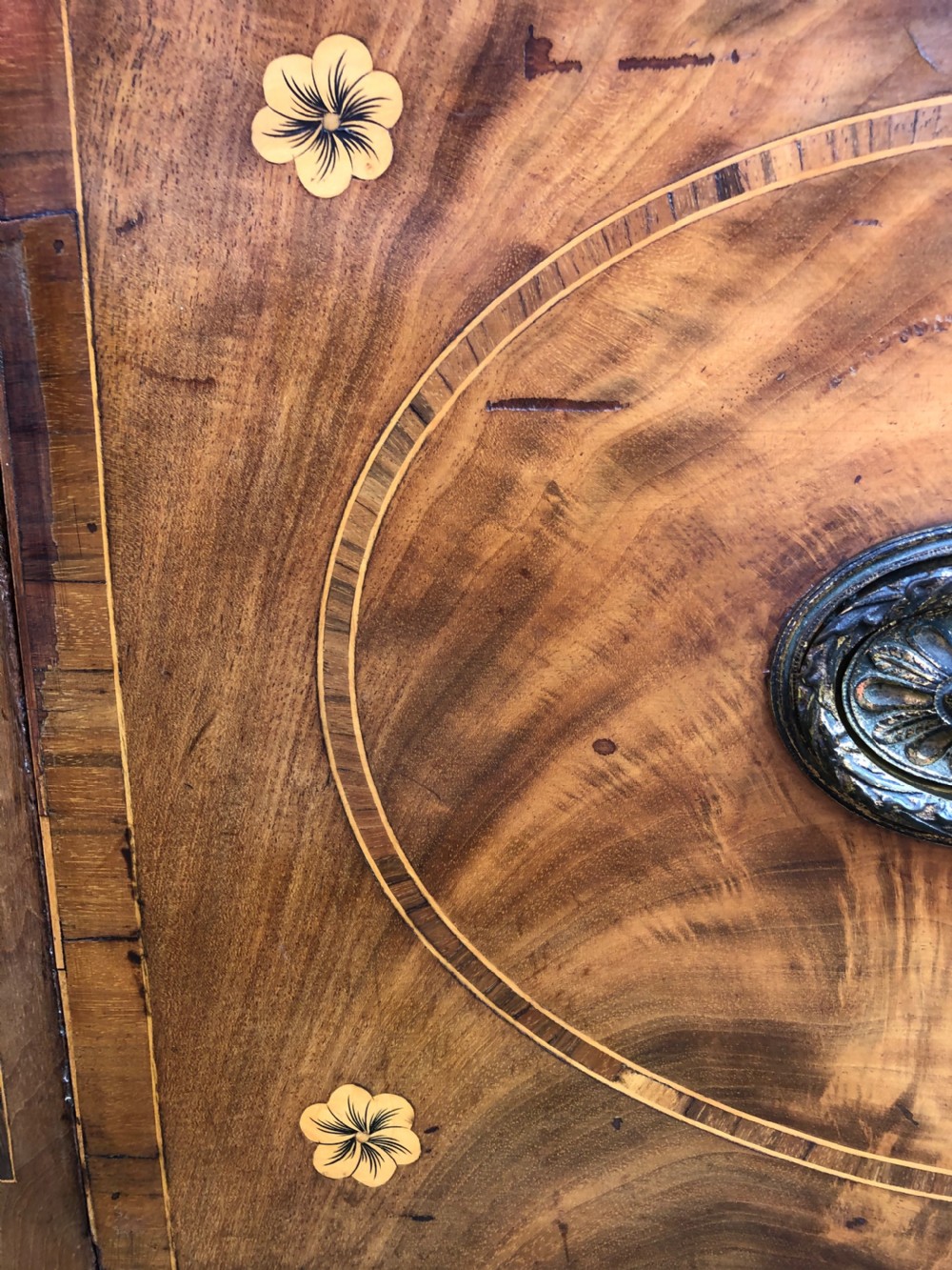 A late 18th-century George III mahogany sideboard featuring a serpentine front, floral marquetry inlay, tapering square legs with spade feet, and brass oval handles. View IX