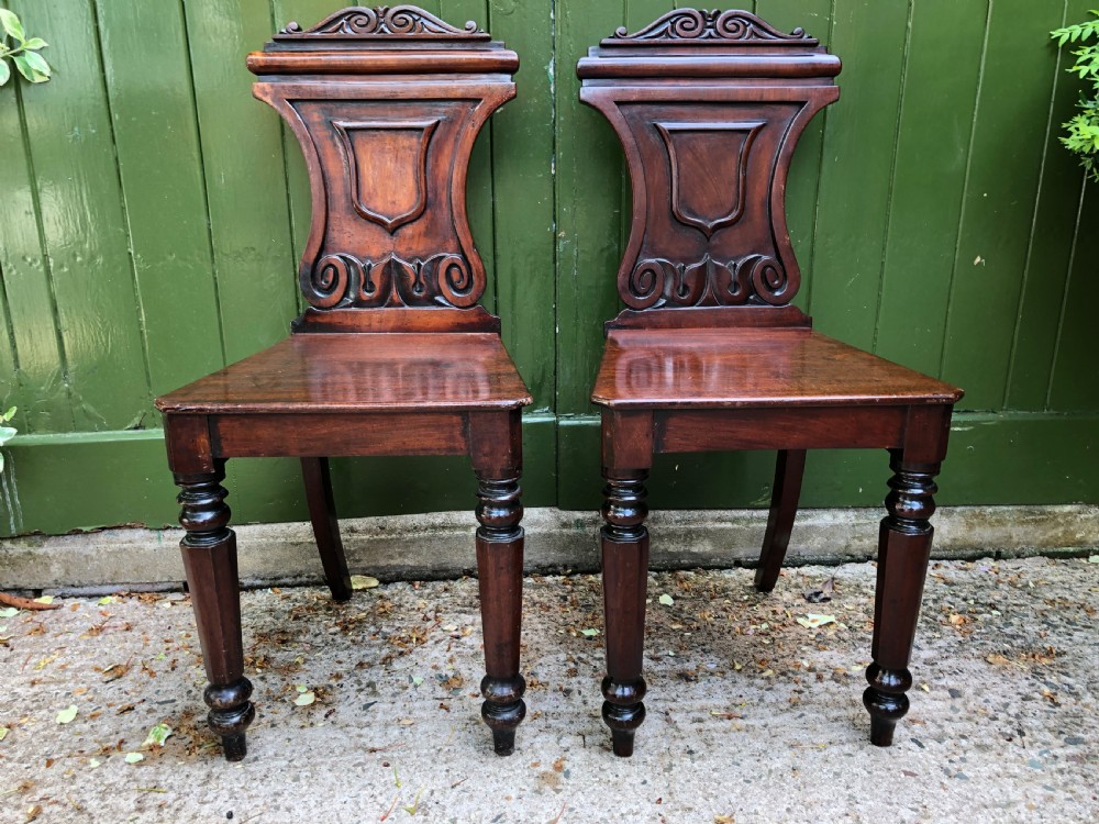 Pair of early C19th George IV period mahogany hall chairs of Grecian revival design. View III