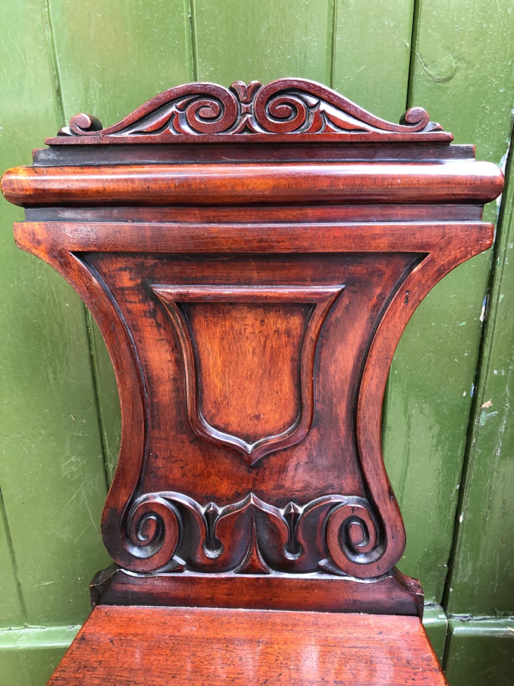 Pair of early C19th George IV period mahogany hall chairs of Grecian revival design. View IV