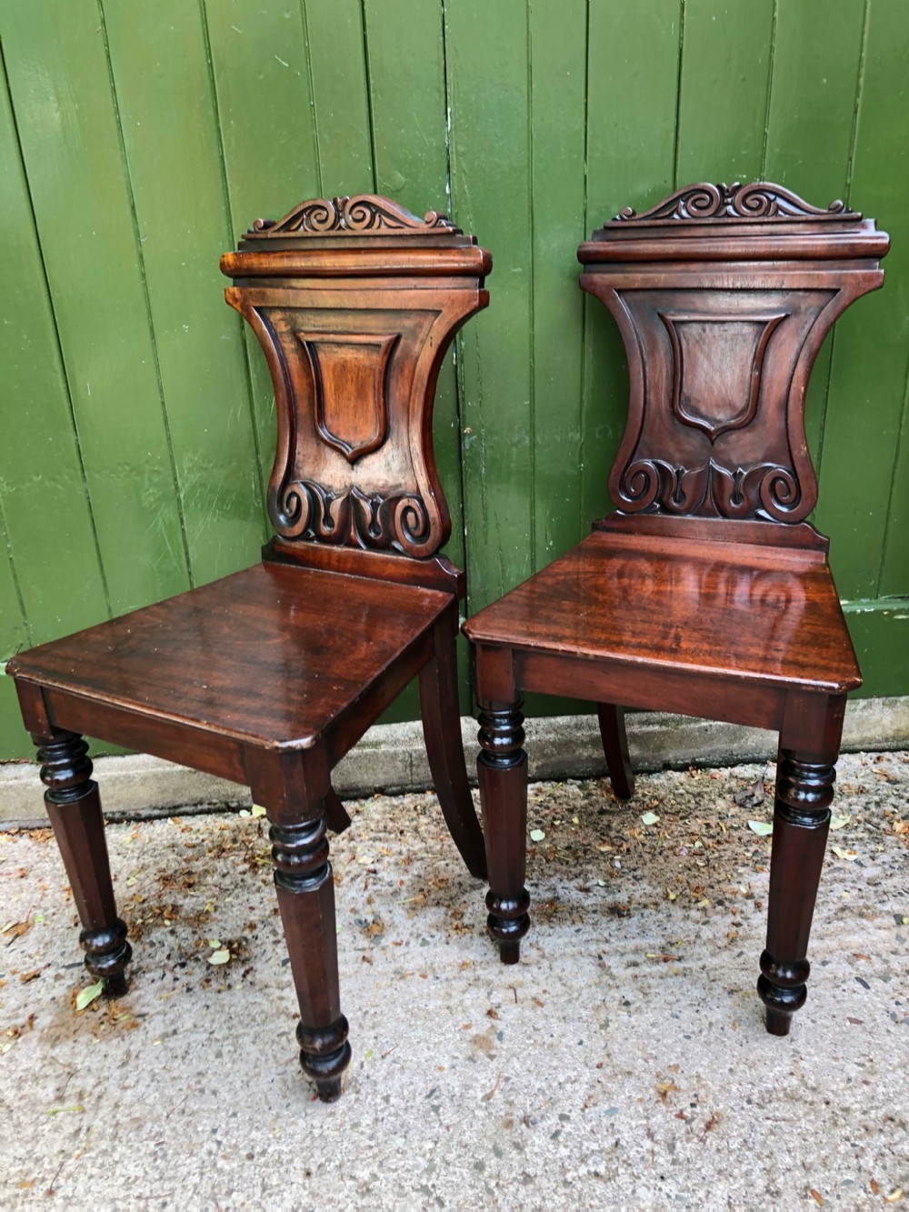 Pair of early C19th George IV period mahogany hall chairs of Grecian revival design. View X