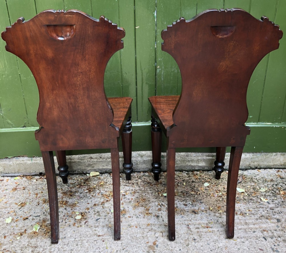 Pair of early C19th George IV period mahogany hall chairs of Grecian revival design. View VI