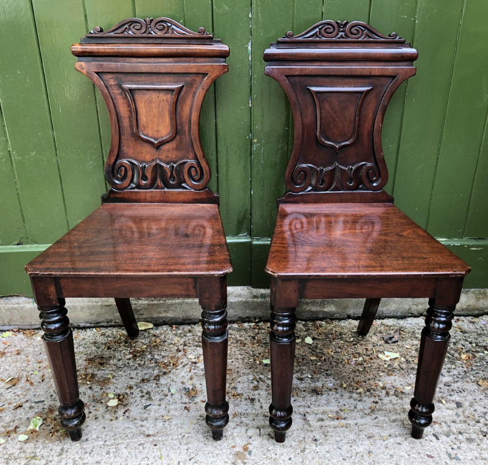 Pair of early C19th George IV period mahogany hall chairs of Grecian revival design. View XIV
