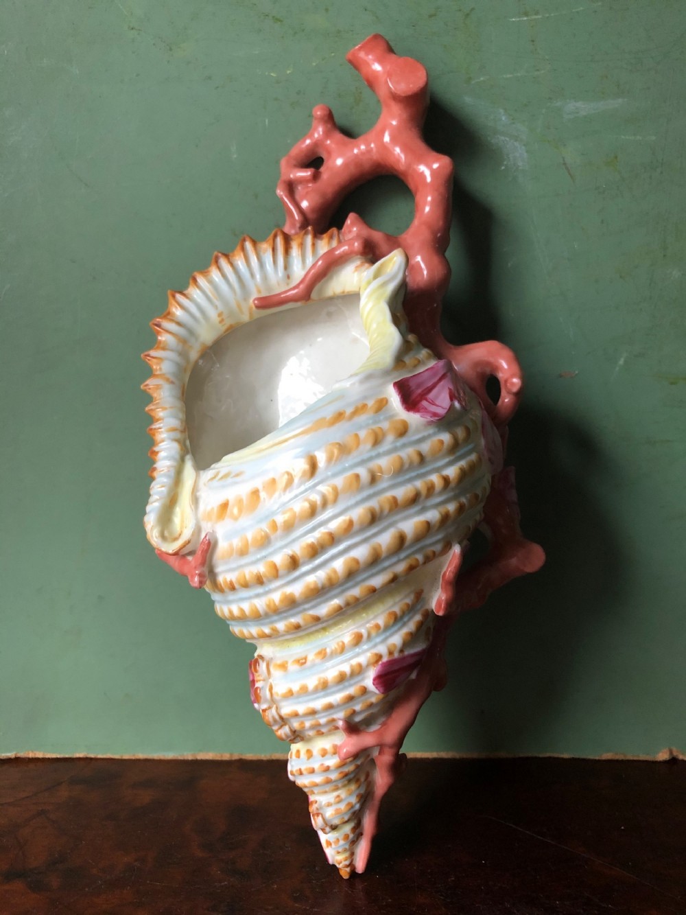 C19th Royal Worcester porcelain wall-pocket modelled as a sea-shell wrapped with coral branches.