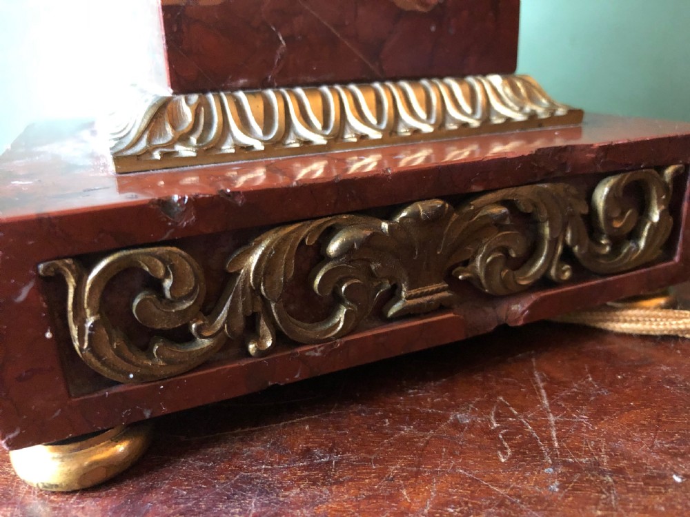Late 19th-century French Empire style table lamp featuring a dark patinated bronze fluted column on a red marble base with gilded ormolu accents. View VI
