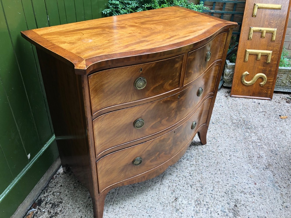 Early C19th Regency period mahogany serpentine-outline chest of drawers . View III