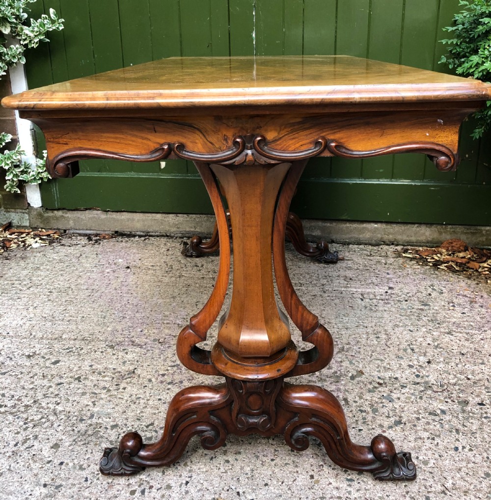 Mid C19th early Victorian period carved walnut centre or library table of free-standing form . View V