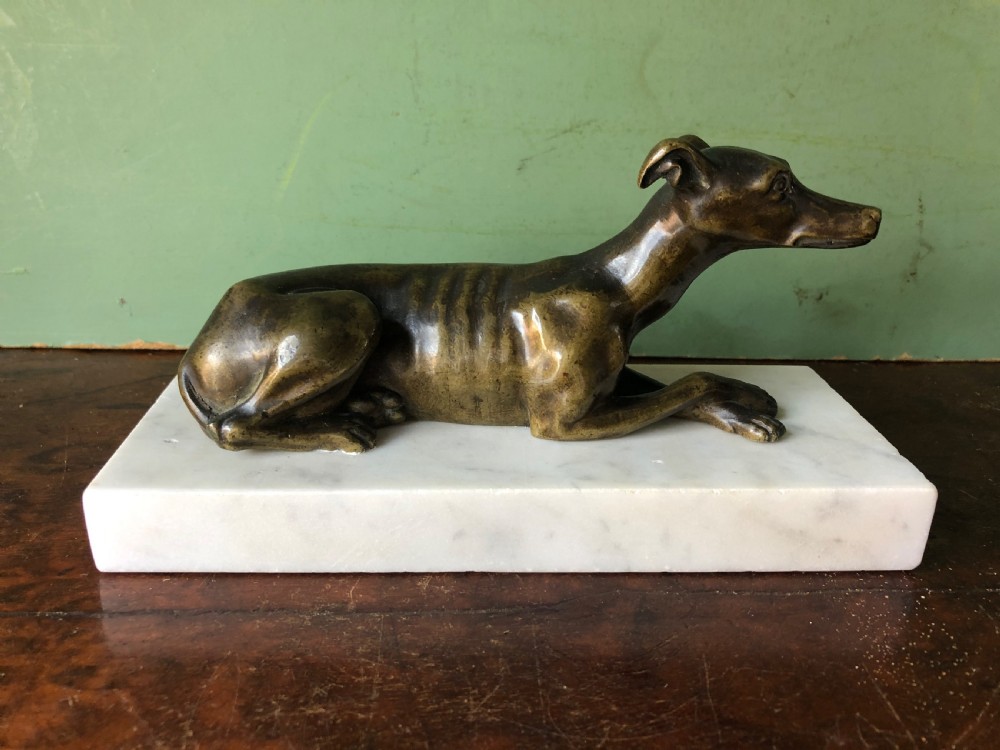 C19th Regency period bronze greyhound or whippet on carrara marble block base.