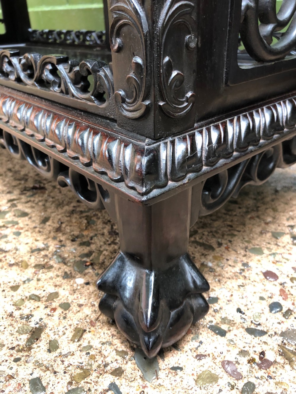 A dark rosewood late nineteenth-century Chinese display cabinet featuring intricate openwork carving throughout tiered open shelves and a crest rail. View XI