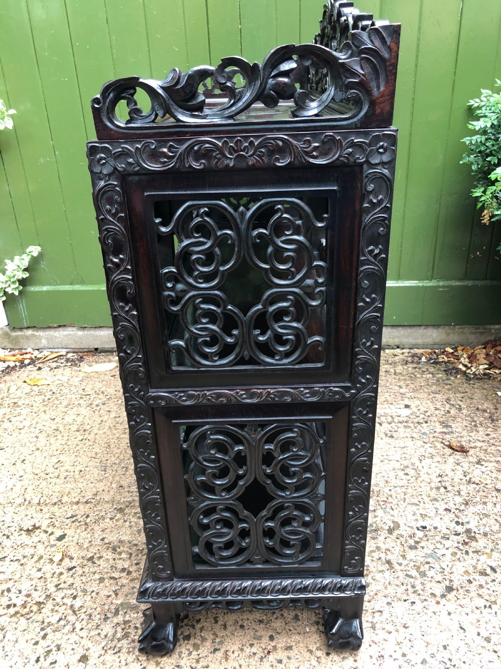 A dark rosewood late nineteenth-century Chinese display cabinet featuring intricate openwork carving throughout tiered open shelves and a crest rail. View XIII
