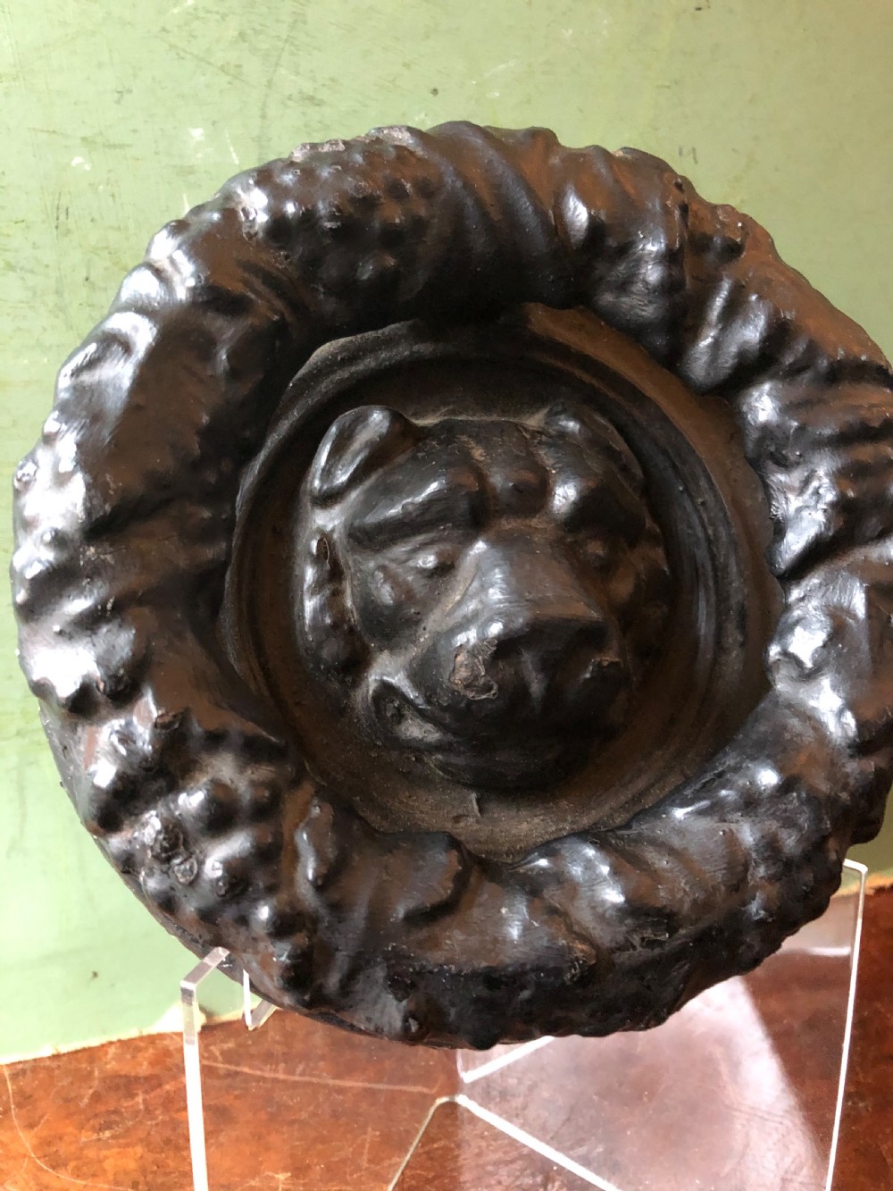 C19th Regency period cast-iron door knocker modelled as a laurel wreath ring with a leopard’s mask centre . View IV