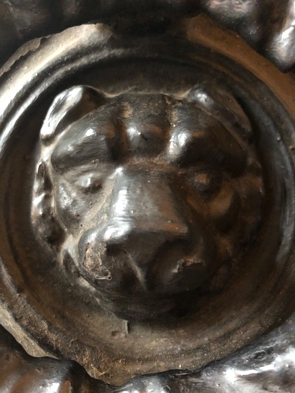C19th Regency period cast-iron door knocker modelled as a laurel wreath ring with a leopard’s mask centre . View V