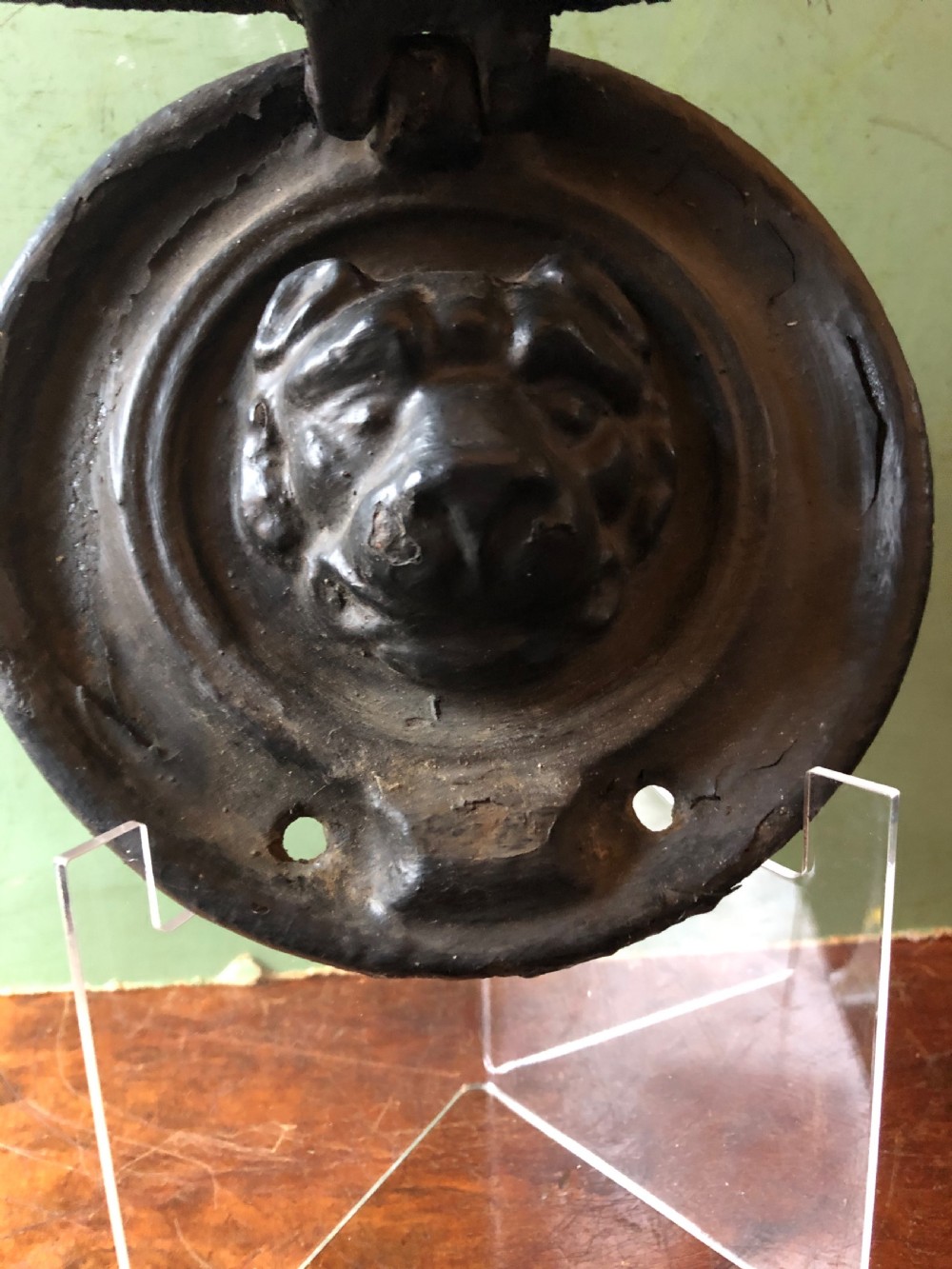C19th Regency period cast-iron door knocker modelled as a laurel wreath ring with a leopard’s mask centre . View VI