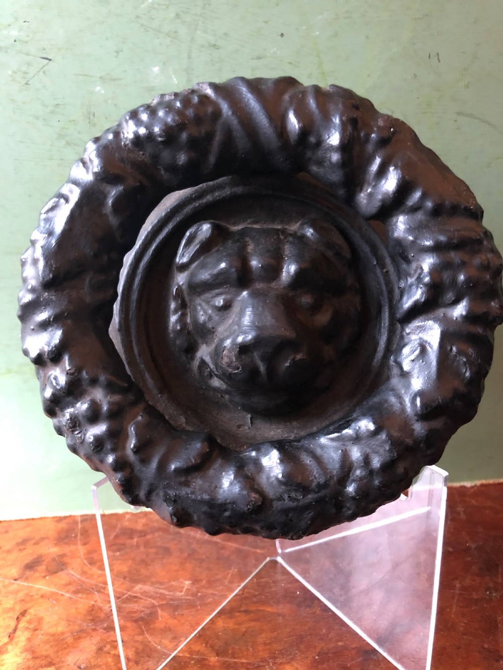 C19th Regency period cast-iron door knocker modelled as a laurel wreath ring with a leopard’s mask centre . View IX