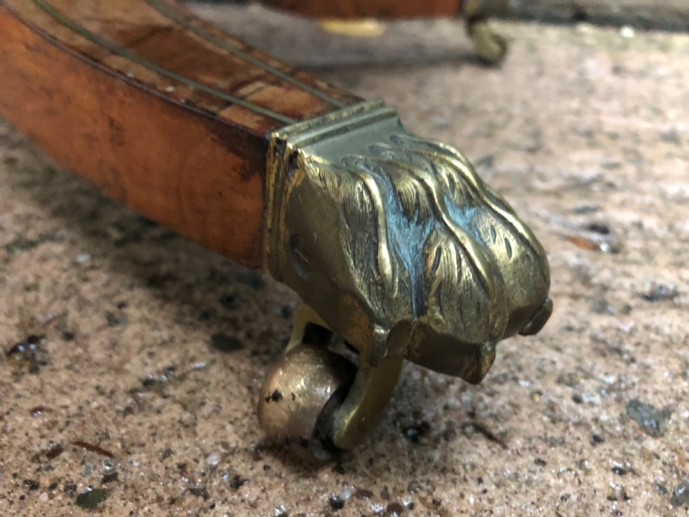 An early nineteenth-century Regency rosewood fold-over card table featuring decorative brass line inlay, a central pedestal, and splayed legs with brass claw feet. View XVI