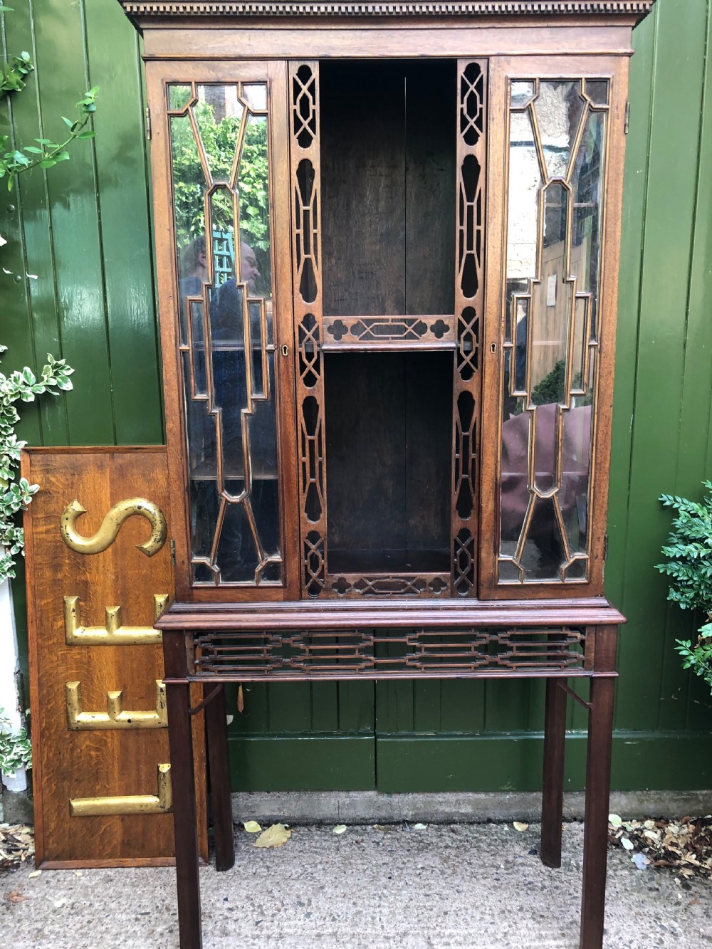 A mid-19th-century Chinese Chippendale revival mahogany glazed china display cabinet elevated on a matching stand with geometric fretwork detail. View II
