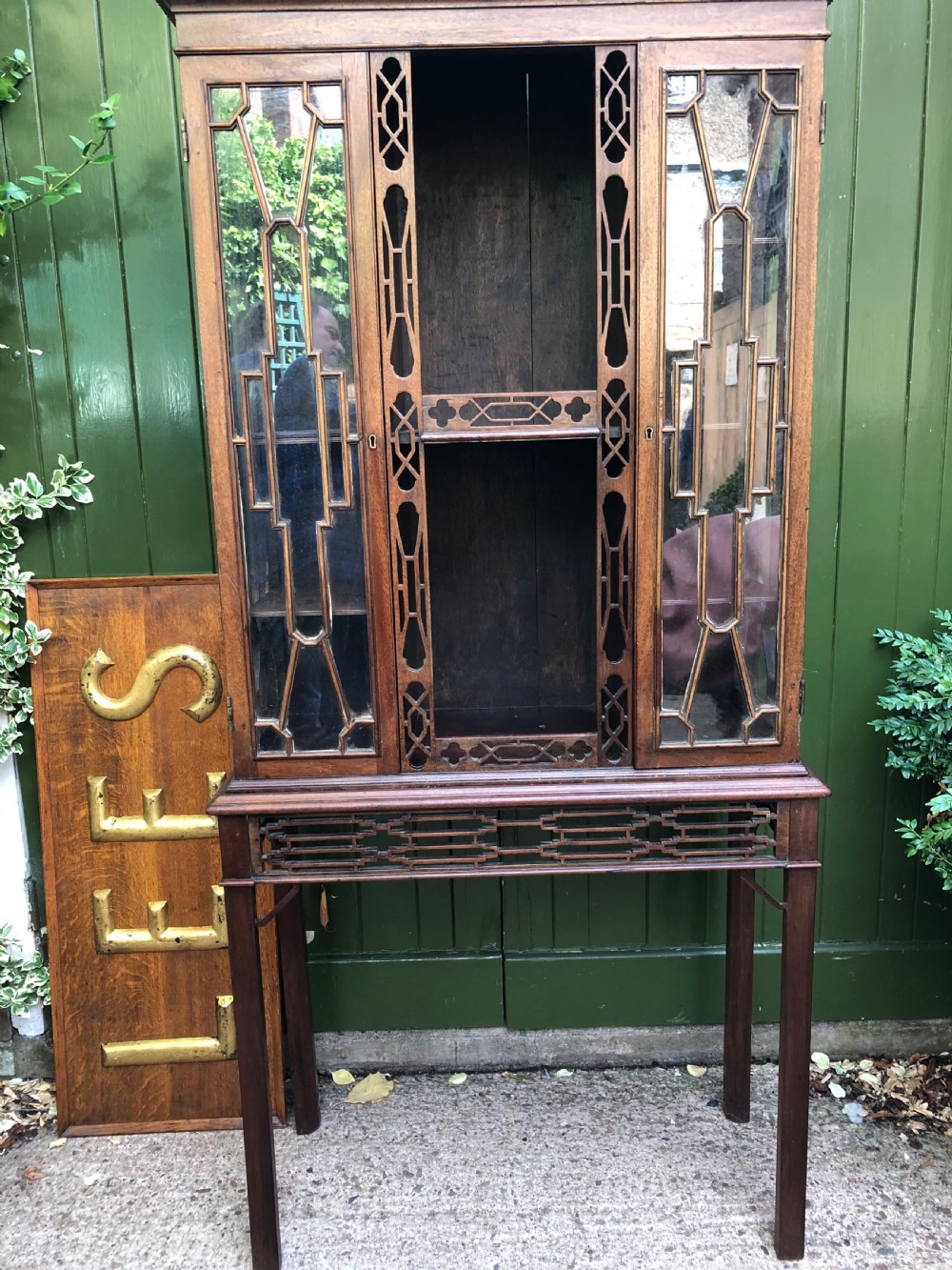 A mid-19th-century Chinese Chippendale revival mahogany glazed china display cabinet elevated on a matching stand with geometric fretwork detail. View III