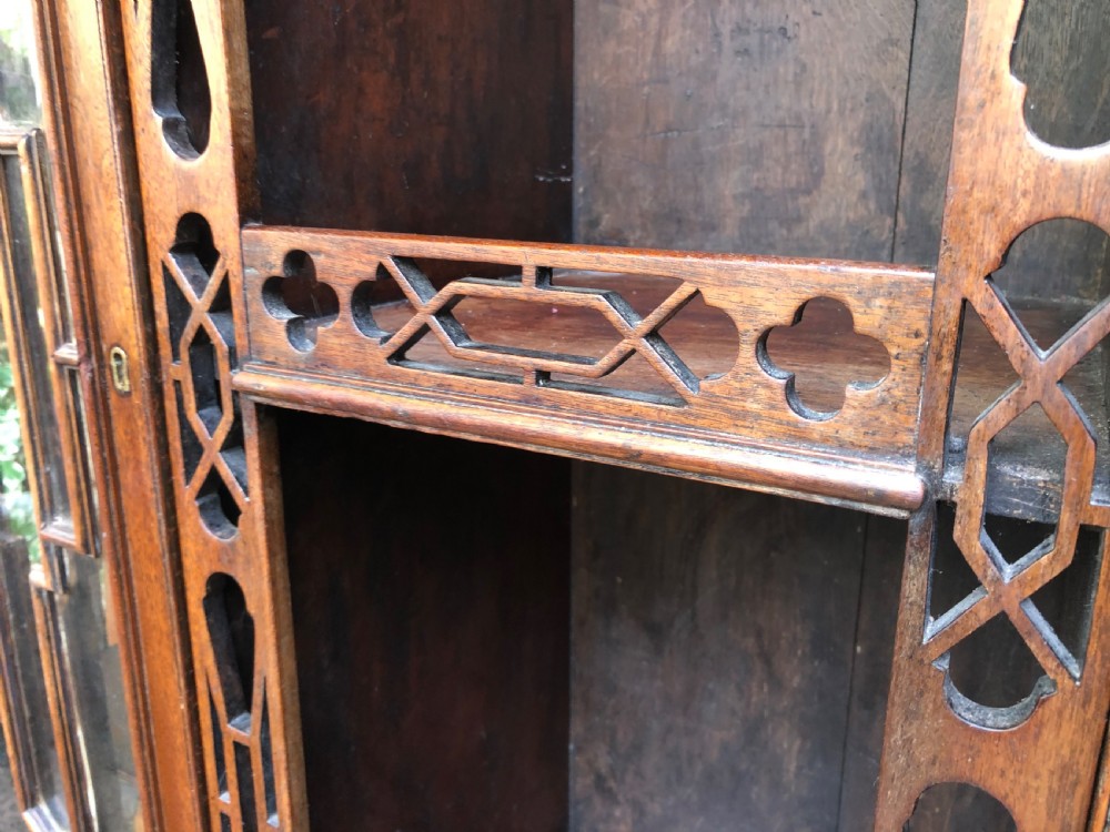 A mid-19th-century Chinese Chippendale revival mahogany glazed china display cabinet elevated on a matching stand with geometric fretwork detail. View VII