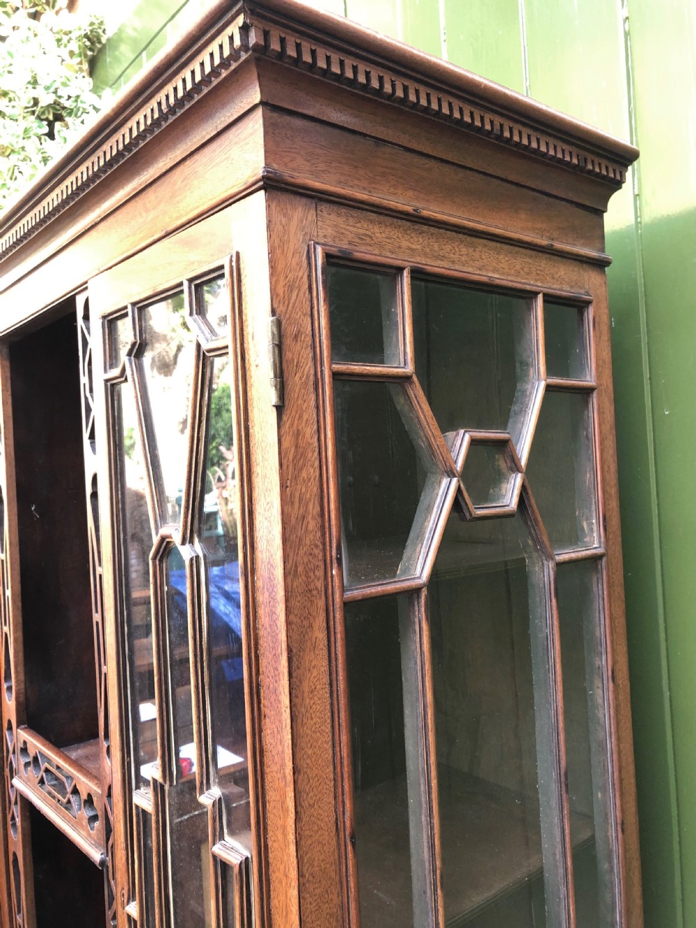 A mid-19th-century Chinese Chippendale revival mahogany glazed china display cabinet elevated on a matching stand with geometric fretwork detail. View VIII