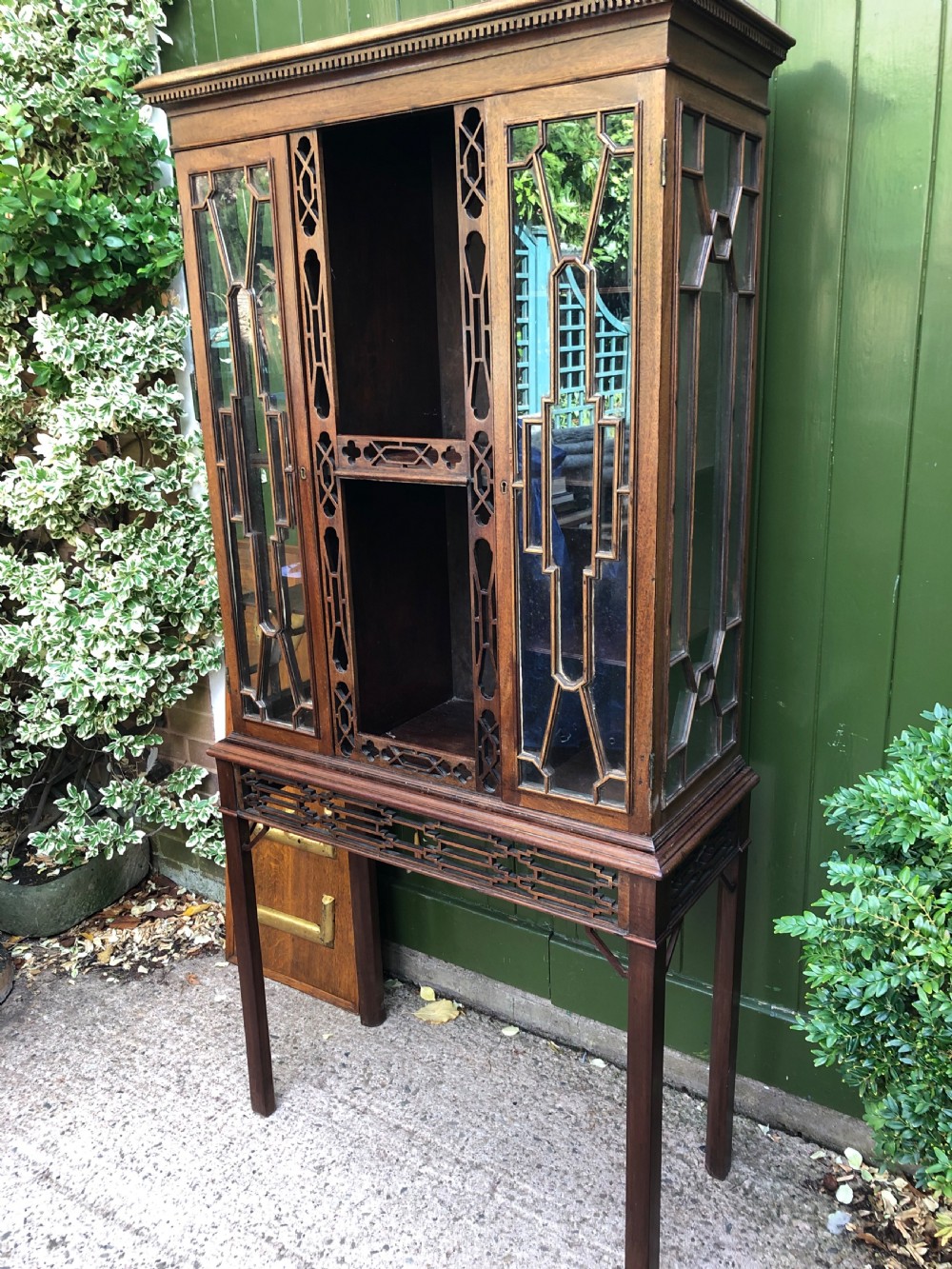 A mid-19th-century Chinese Chippendale revival mahogany glazed china display cabinet elevated on a matching stand with geometric fretwork detail. View IX