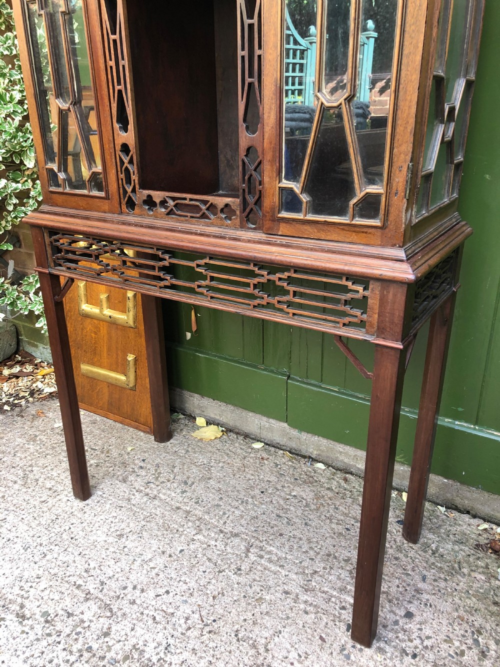 A mid-19th-century Chinese Chippendale revival mahogany glazed china display cabinet elevated on a matching stand with geometric fretwork detail. View X