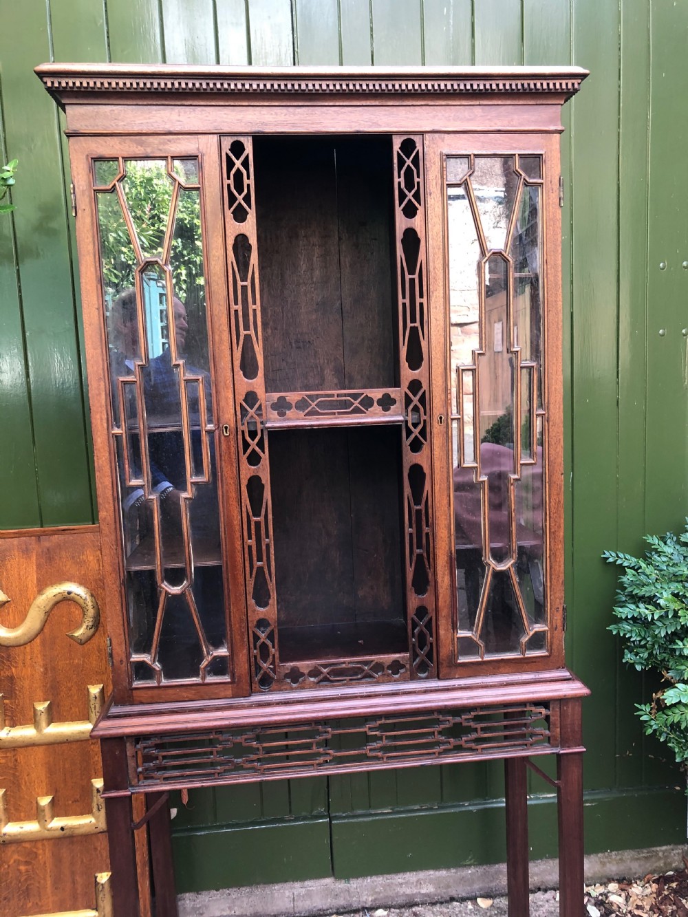 A mid-19th-century Chinese Chippendale revival mahogany glazed china display cabinet elevated on a matching stand with geometric fretwork detail. View XII