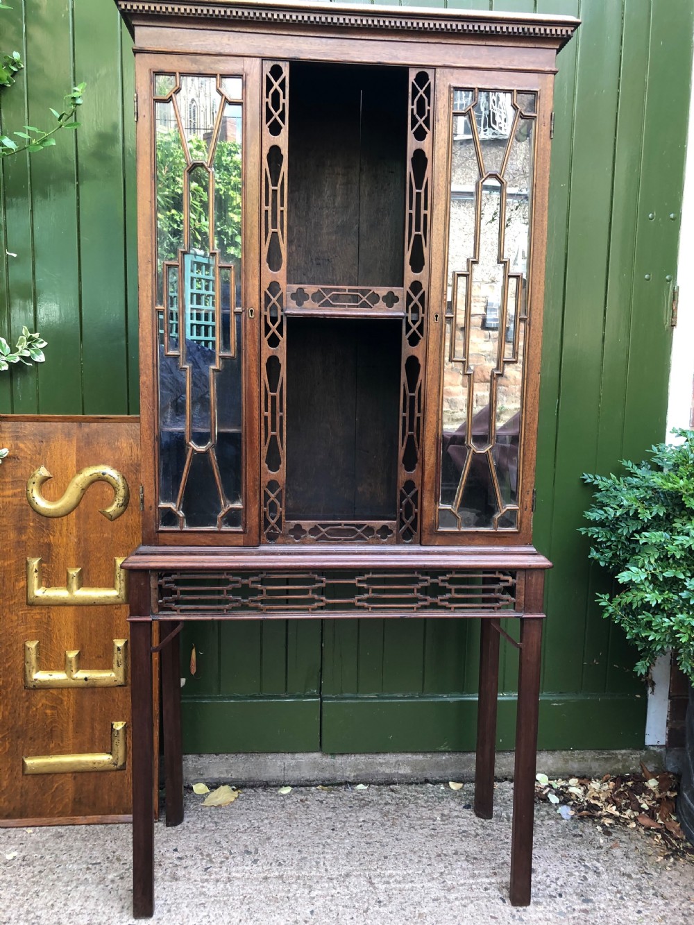 A mid-19th-century Chinese Chippendale revival mahogany glazed china display cabinet elevated on a matching stand with geometric fretwork detail. View XIV