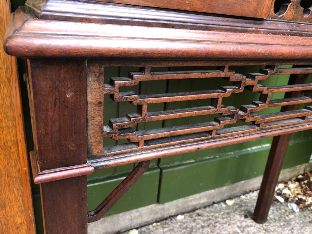 A mid-19th-century Chinese Chippendale revival mahogany glazed china display cabinet elevated on a matching stand with geometric fretwork detail. View XVI