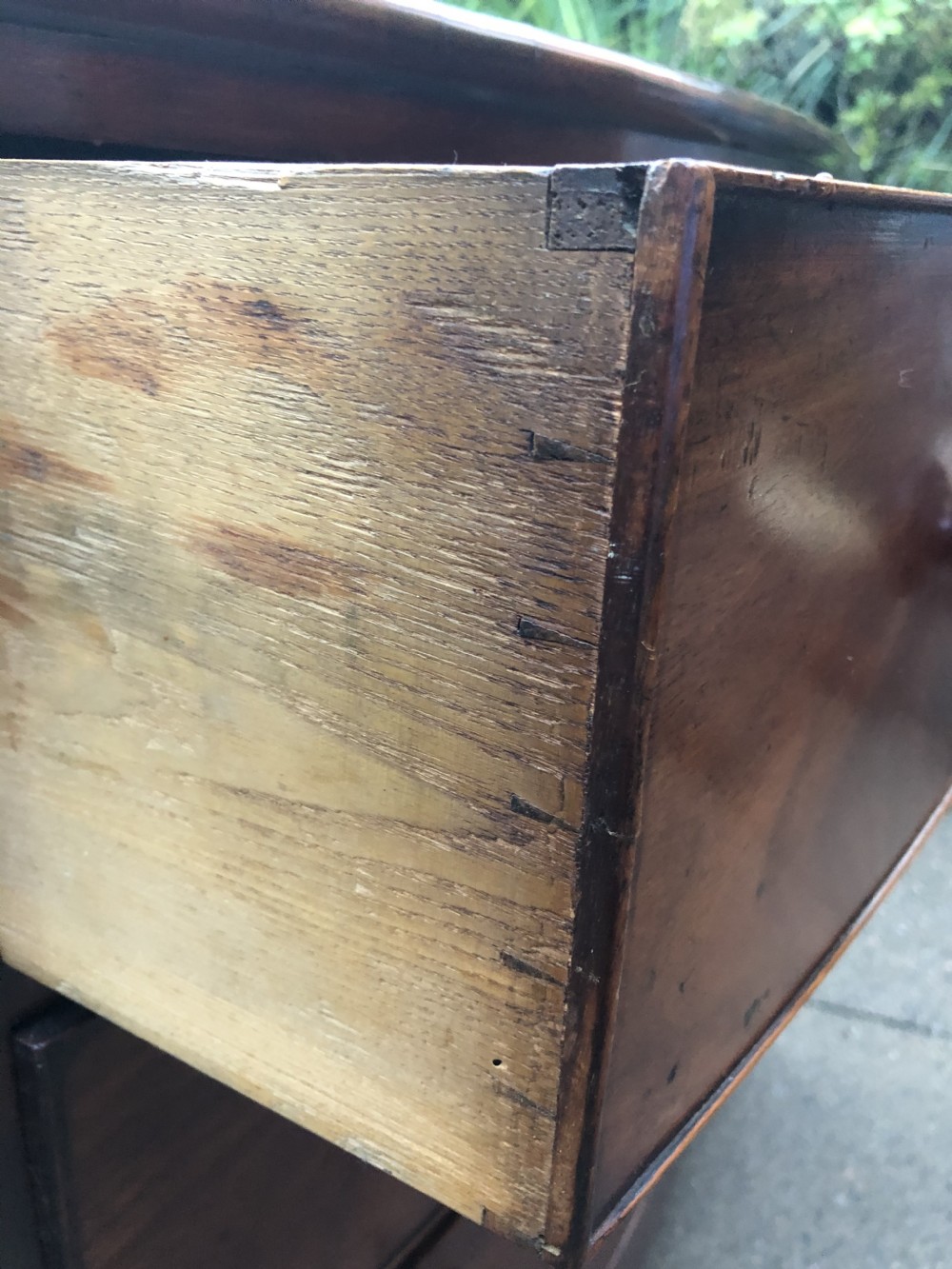 An early nineteenth-century George III mahogany bowfront chest of drawers featuring two short over two long drawers with turned knobs and splayed bracket feet. View IX
