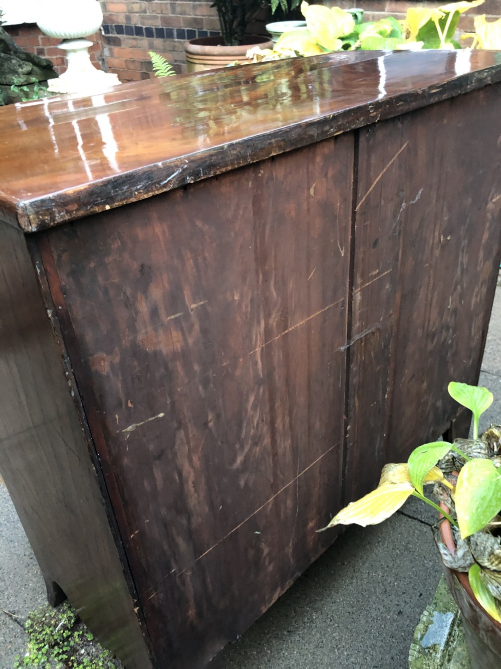 An early nineteenth-century George III mahogany bowfront chest of drawers featuring two short over two long drawers with turned knobs and splayed bracket feet. View XIII